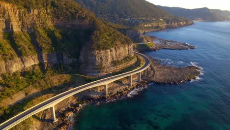 scenic road on rocky cliffs at sea cliff bridge in northern illawarra region of new south wales, australia