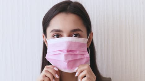 woman wearing a pink face mask