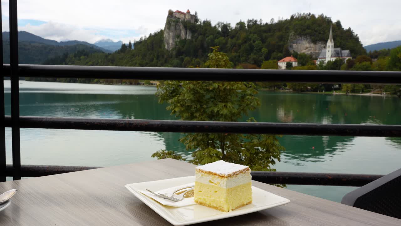 Bled cream cake by lakeside at Kavarna Park Cafe, serene and picturesque place