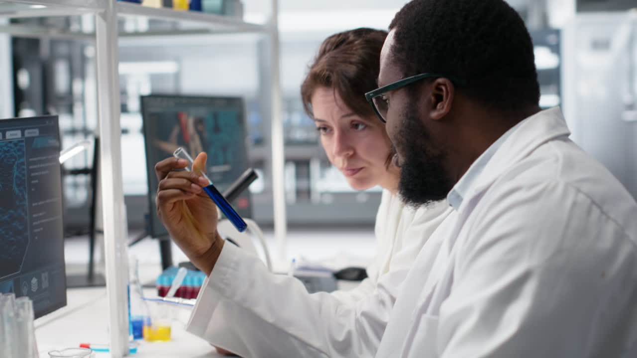 Vertical video Team of lab technicians using chemical solutions, creating mixtures