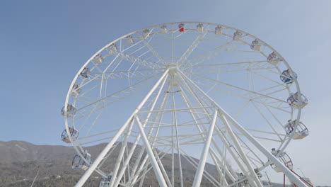 white ferris wheel against a blue sky