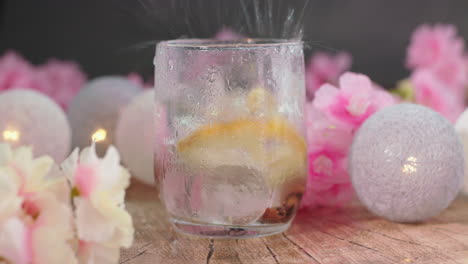 Throwing-ice-blocks-in-a-sparkling-summer-tonic-drink,-surrounded-by-a-colourful,-vibrant-composition