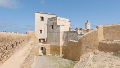 Passage-along-fortress-wall,-mosque-in-background