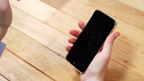 businesswoman using mobile phone at desk