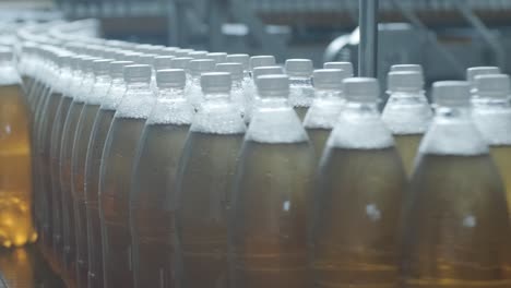 conveyor belt with bottles for juice or water at a modern beverage plant. modern production of sweet soda water