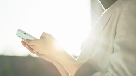 Hands,-outdoor-and-woman-with-a-cellphone