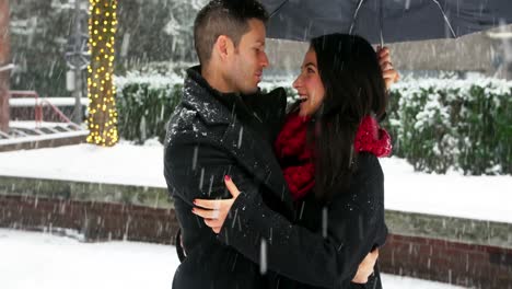 Couple-interacting-with-each-other-under-umbrella