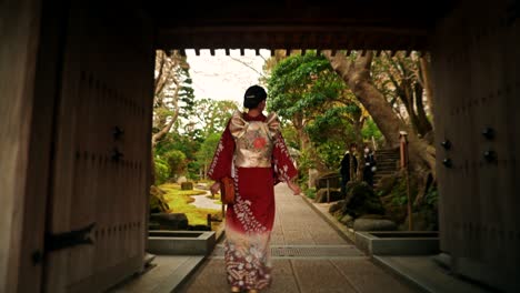 japanese woman in kimono walking through a temple garden