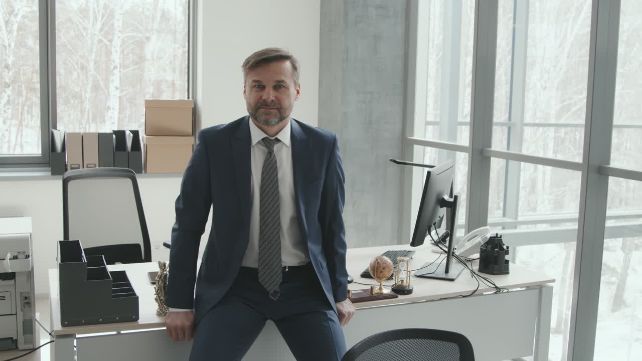 Mature Male Lawyer in Suit Leaning on Table
