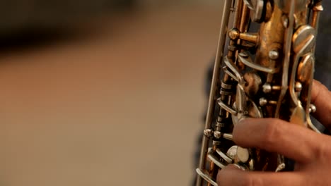 close up handheld shot of musician playing wind instrument during event