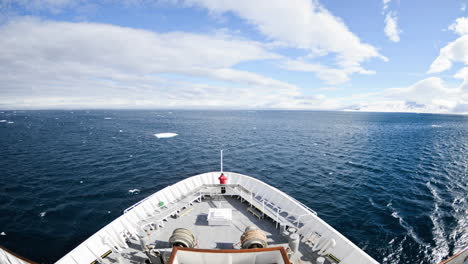 bow point of view time lapse of one person on a ship cruising in the sea through lomfjorden in svalbard archipelago norway