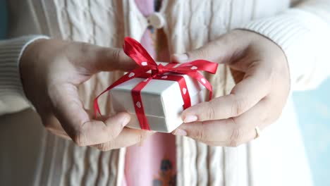 woman holding a small gift box