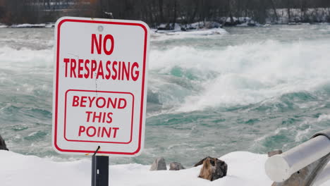 sign warning of danger on niagara river in winter 01