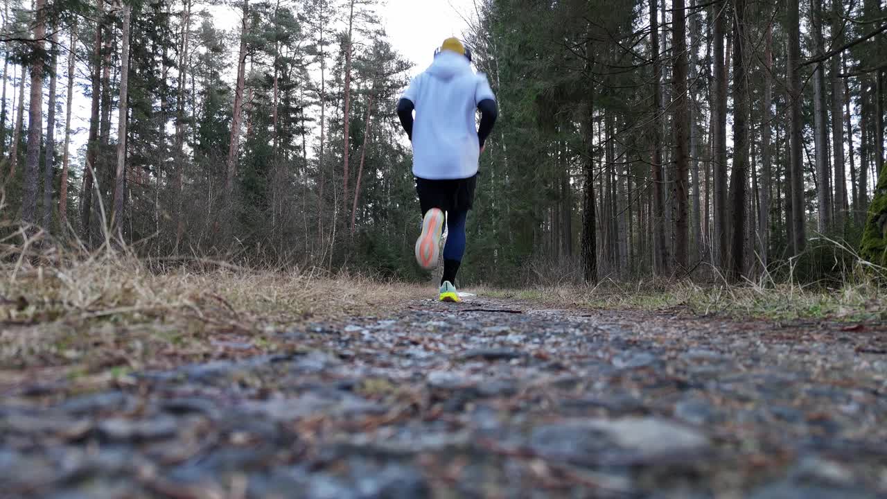 The runner runs over the camera. Forest.