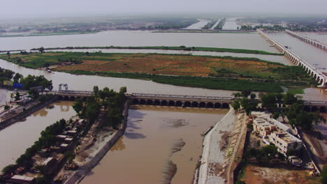 aerial view of twins bridges, twin canals both sides of the river, big canals starting from the river going between the city, traffic is going on, khyberpakhtunkhwa, pakistan