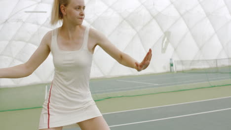 CU-HANDHELD-Young-Caucasian-female-tennis-player-hitting-a-ball-during-game-or-practice.-4K-UHD-RAW-graded-footage