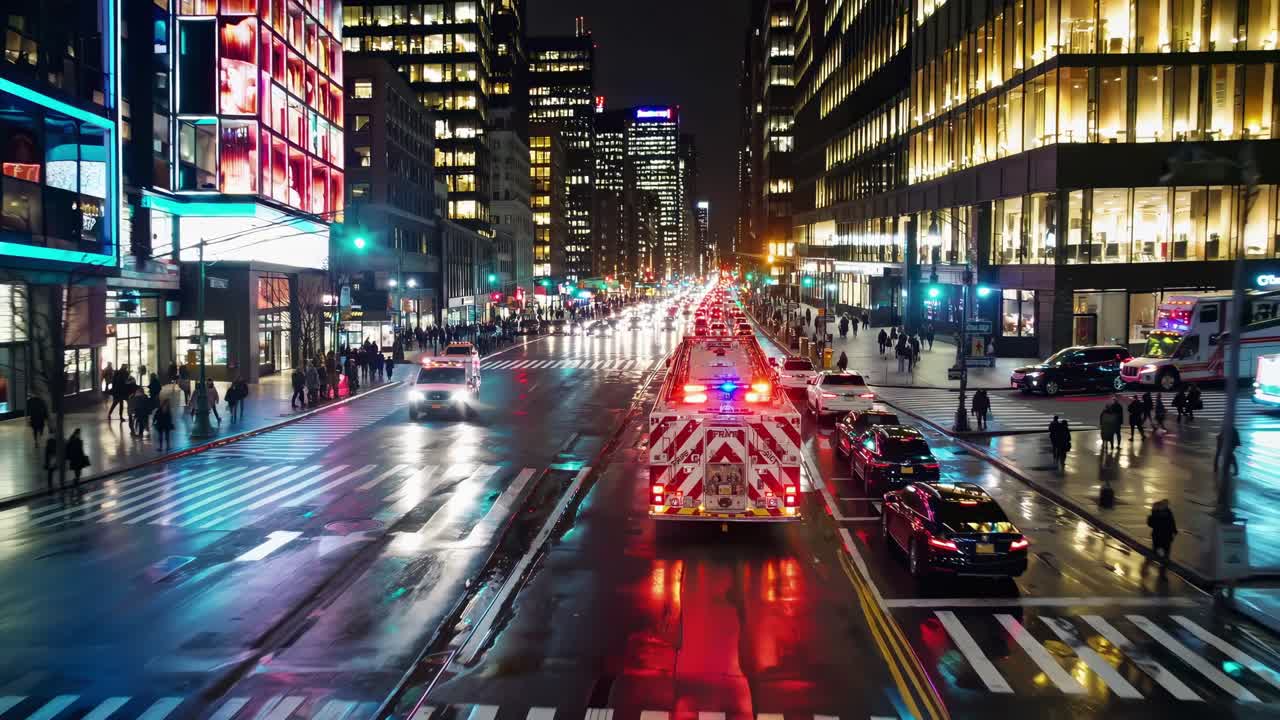 Firetruck with flashing lights driving on a busy street in New York City at night, reflecting on wet asphalt with pedestrians walking on sidewalks and illuminated buildings in background