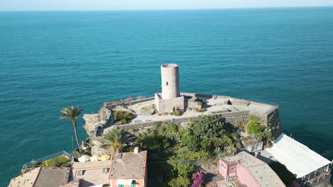 drone orbits above doria tower ruins in vernazza, italy