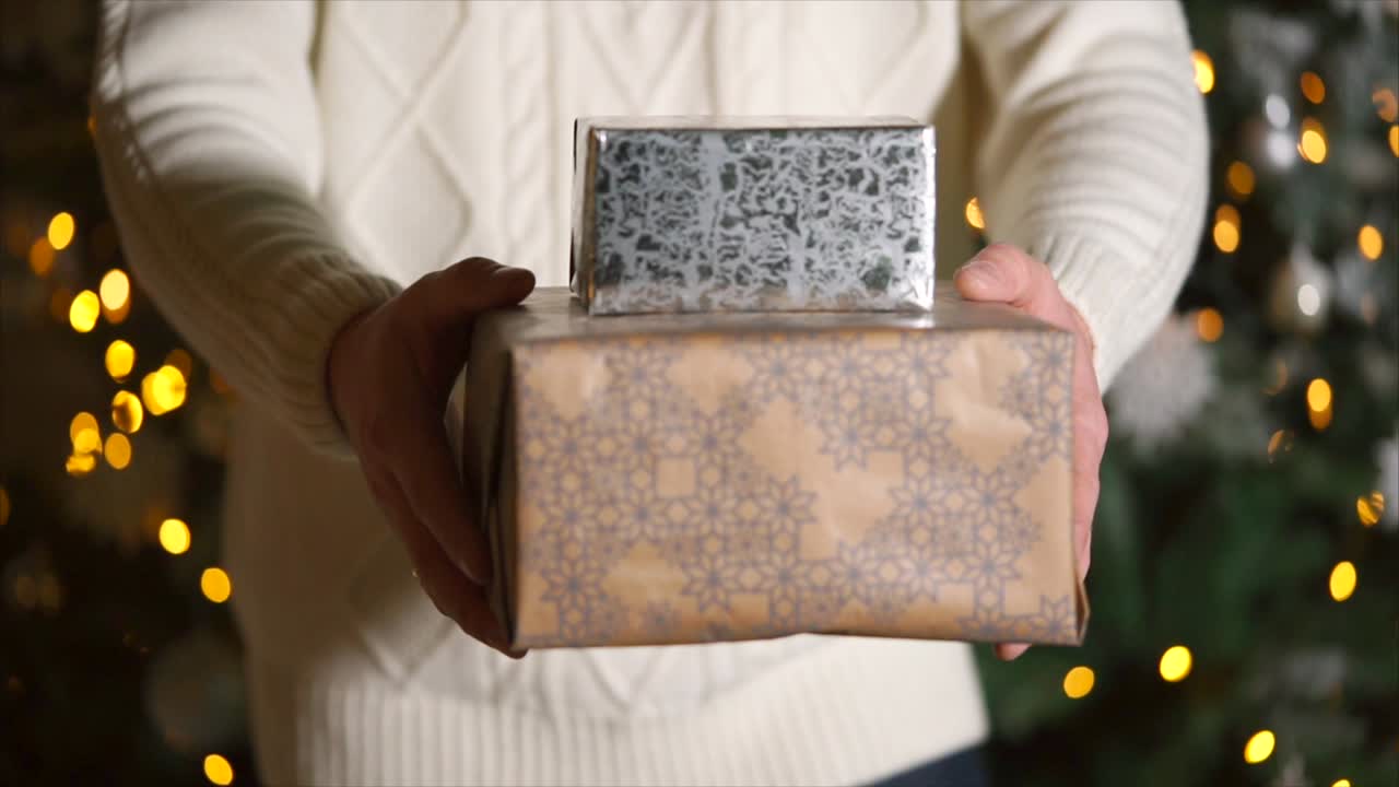 Man holding Christmas gifts