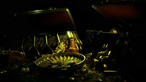 treasure chests filled with gold and jewels displayed under dim lighting