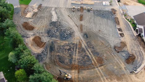 Aerial-slow-ascent-to-a-high-angle-to-reveal-rubble-and-heavy-equipment,-Lancaster-Evangelical-Free-Church,-Lititz-Pennsylvania