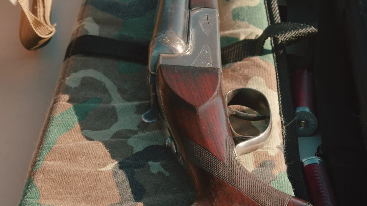 Shotgun resting on the gun case. Camera tilts up