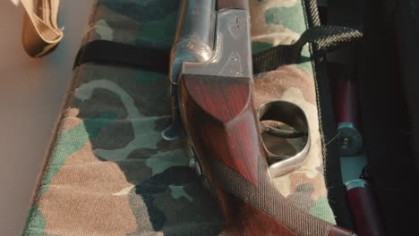 shotgun resting on the gun case. camera tilts up