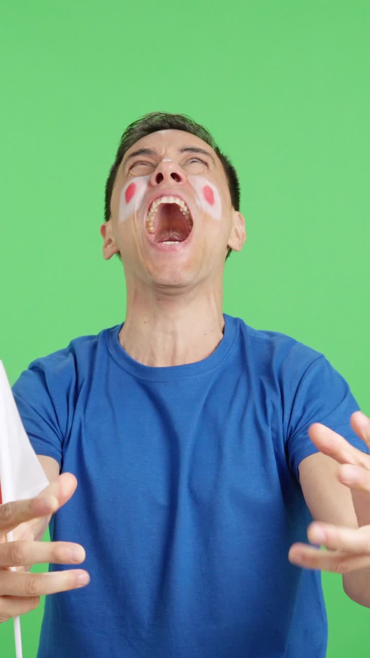 Man cheering for Japan screaming and waving a national flag