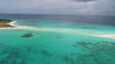 drone shot along cayo de agua with sandbar flooded and different shades of blue, cayo de agua