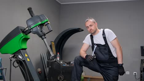mechanic in a workshop holding a wrench