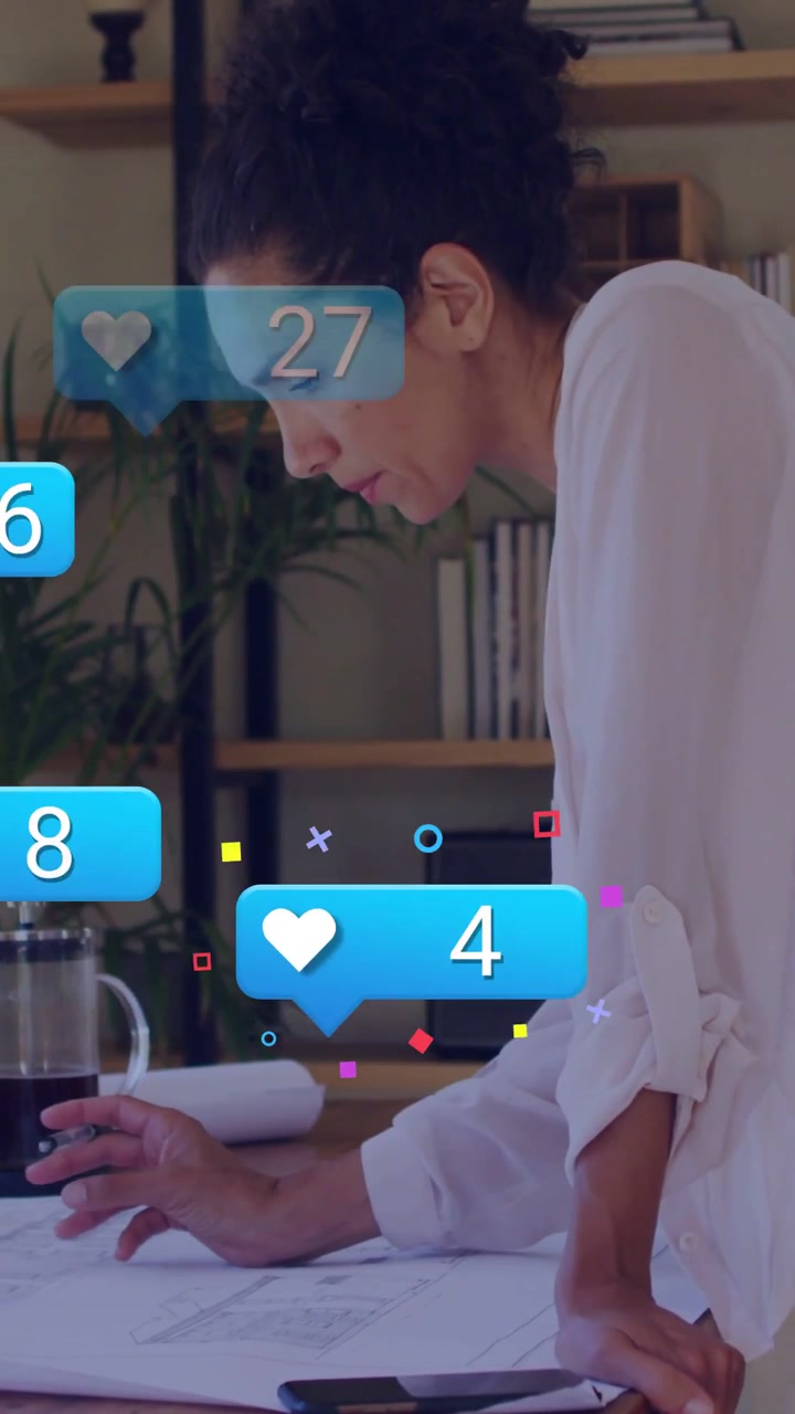 Vertical video: Phone buzzing, designer leaning on plans, marking and refining as icons rising