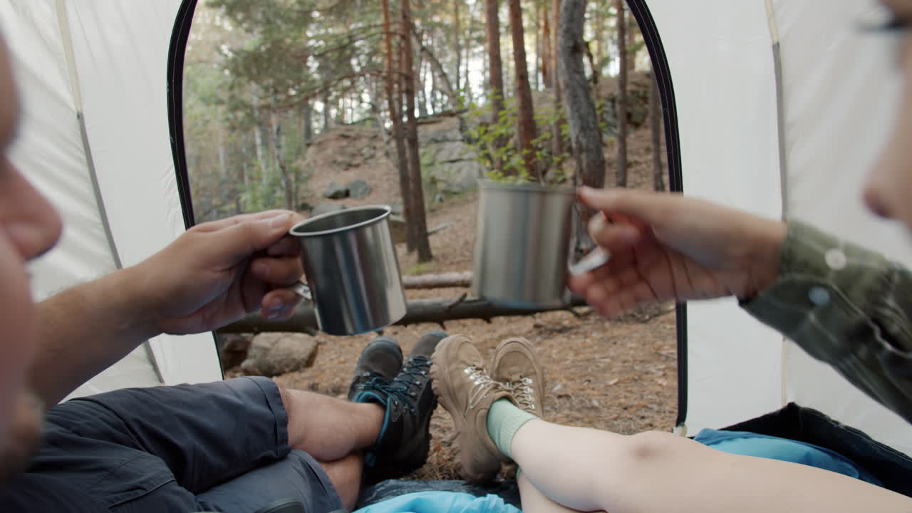 Couple Relaxing Inside Tent in Forest