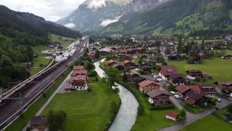 aerial townscape of kandersteg town in switzerland, a swiss alpine village in a valley amid green meadows and alps mountains