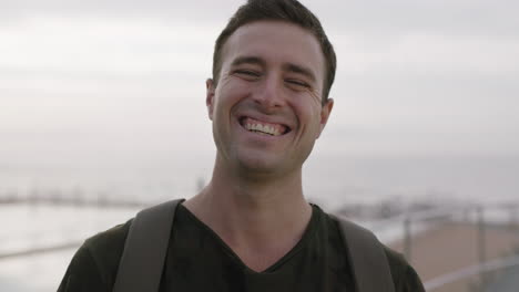 portrait of attractive young man smiling cheerful confident on seaside