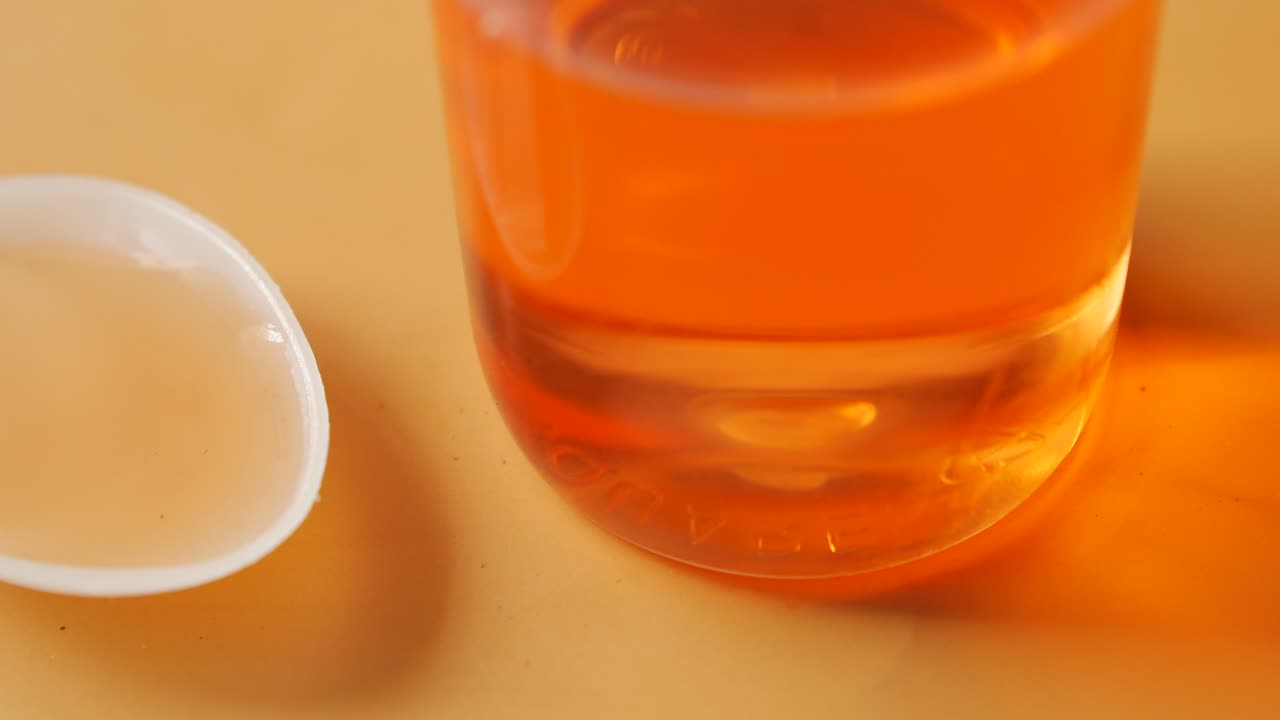 Liquid Medication in a Spoon and Bottle