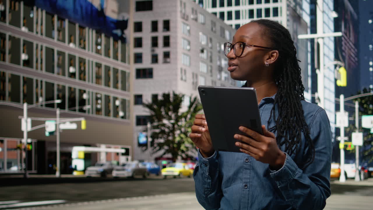 Smiling african american woman using tablet and walking in the city center