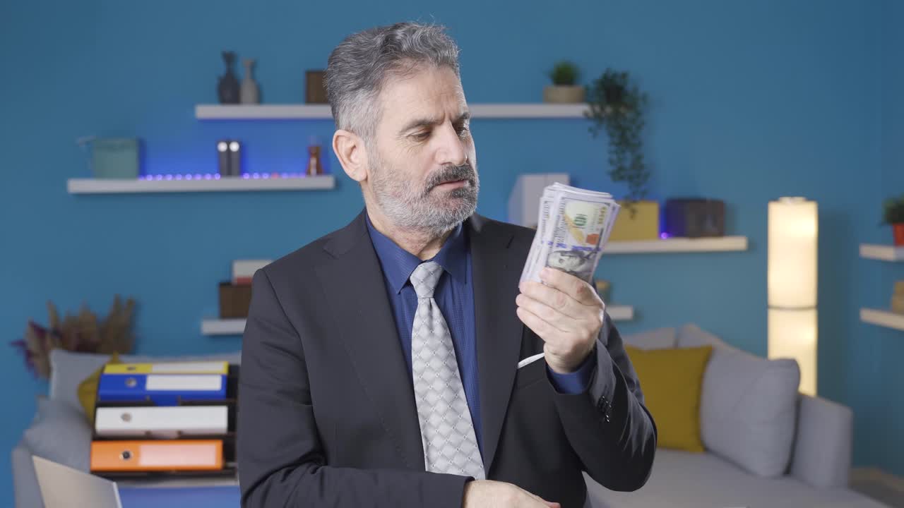 행복한 부유한 사업가가 그의 급여나 수입을 계산하고 있습니다.