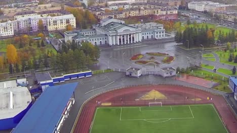 aerial view of a city with a stadium and public spaces