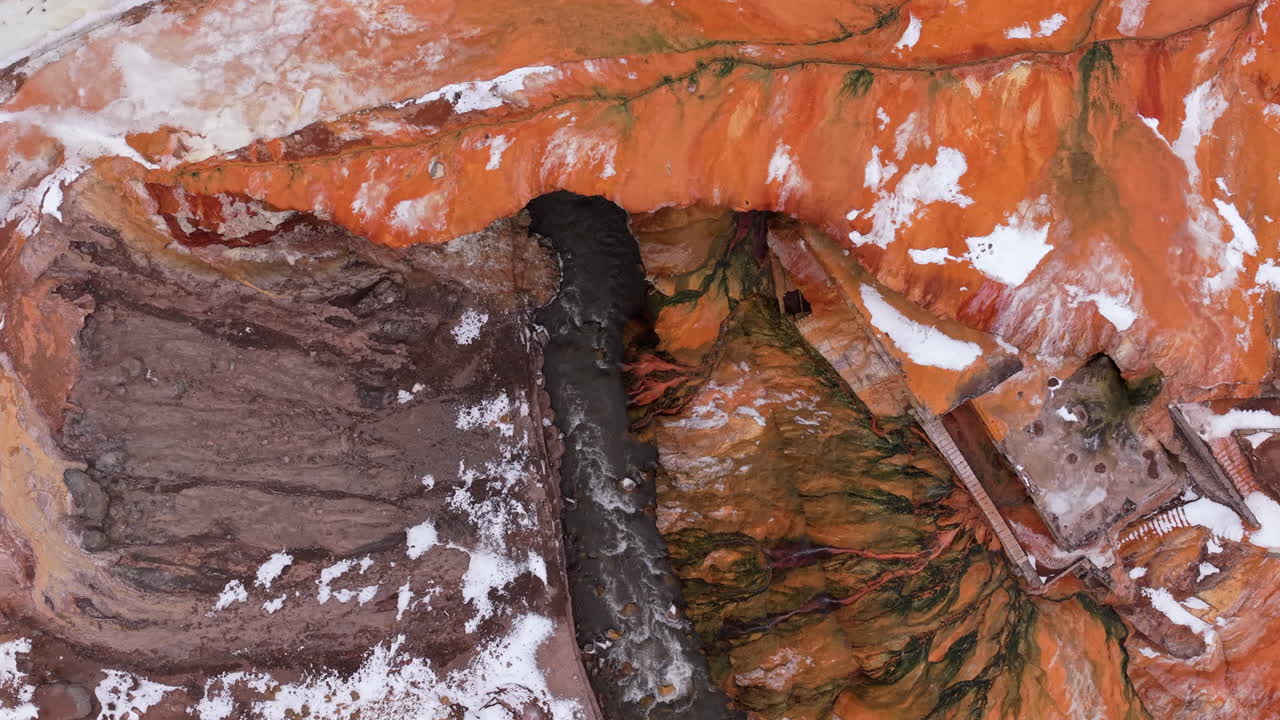 Aerial fly River Flow Through Ocher Mountains at Puente del Inca Mendoza Argentina