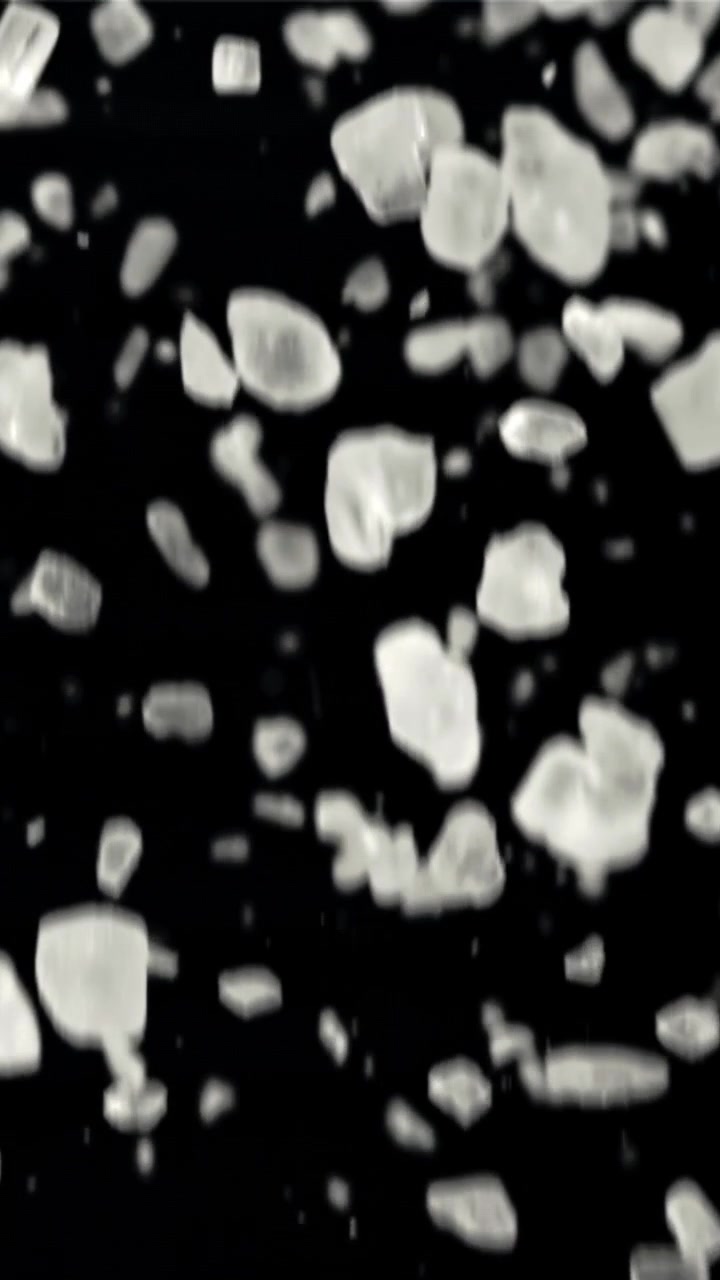 Falling Ice Shards and Particles on Black Background