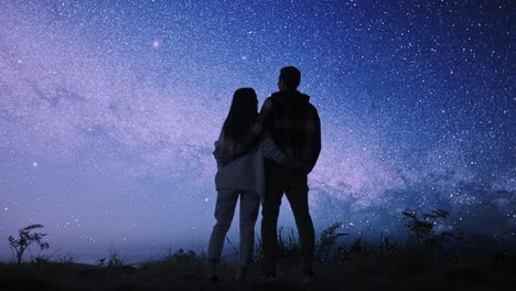 couple gazing at the milky way
