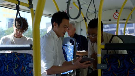 couple discussing over digital tablet while travelling in bus 4k