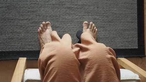 woman sitting in a chair with her feet up