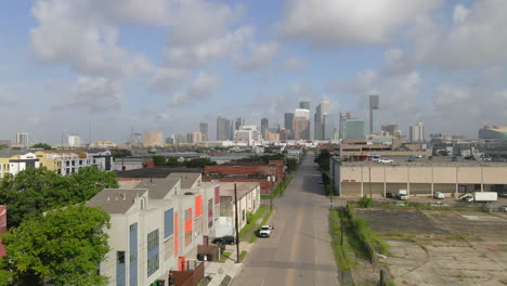 Aerial-view-of-street-with-car-heading-to-downtown-Houston,-Texas,-USA