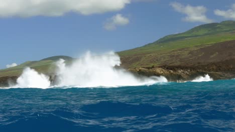 ocean waves crashing on volcanic coastline