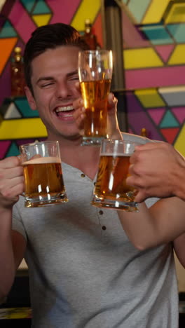 group of friends toasting glass of beers