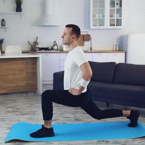fit training at home. fit man exercising at home in living room