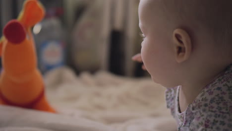 Home-portrait-of-baby-girl-lying-on-bed