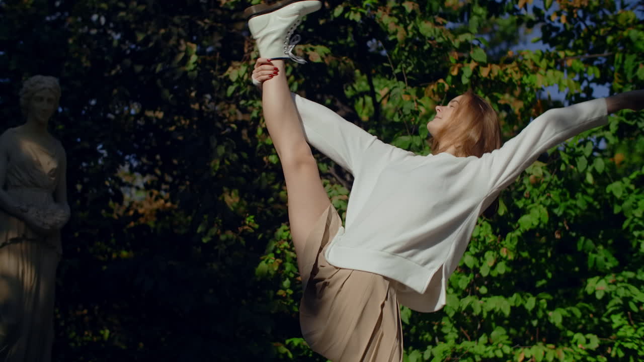 Woman in a park, posing and stretching