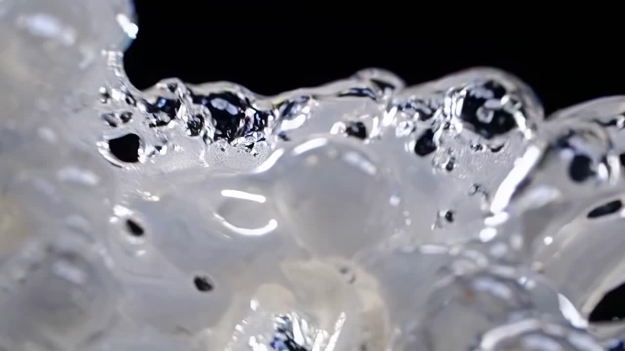 Close-up video shot of intricate soap bubbles with a macro lens, highlighting their delicate